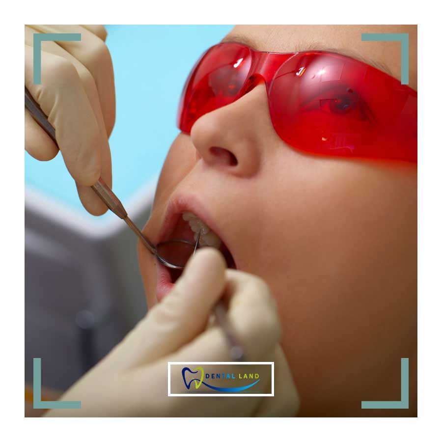 A child with red glasses getting their teeth examined at a family dentist