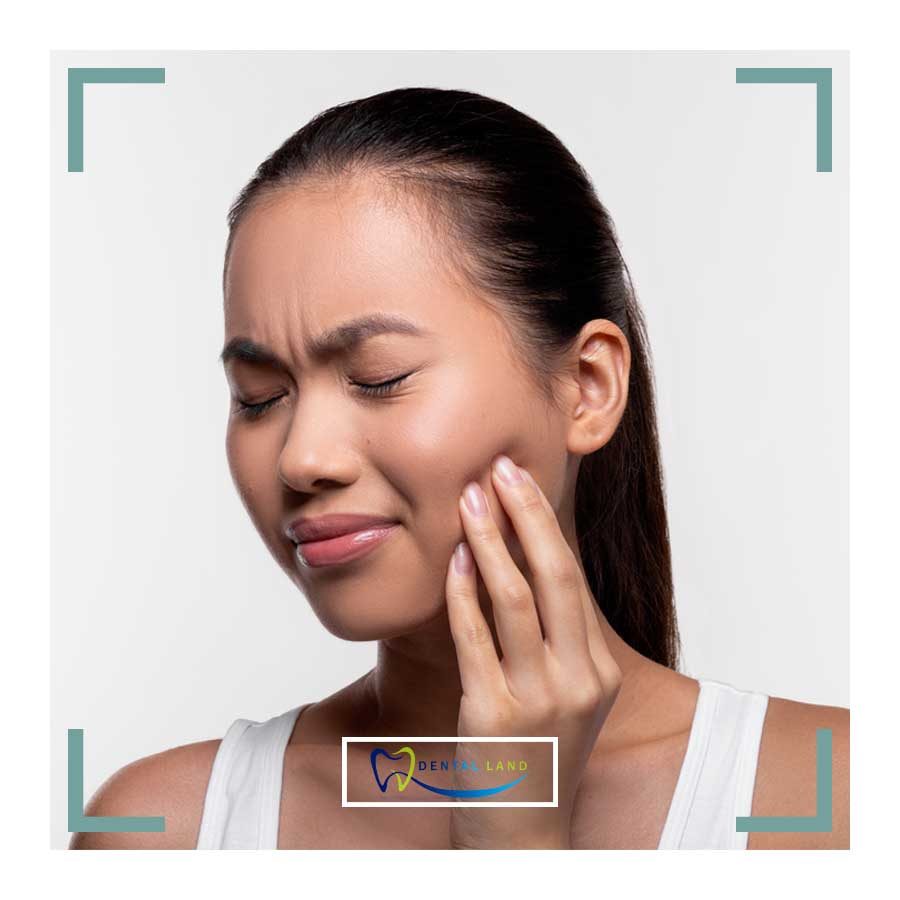 A woman pondering with her hand on her chin, seeking advice on relieving tooth pain, possibly related to periodontics