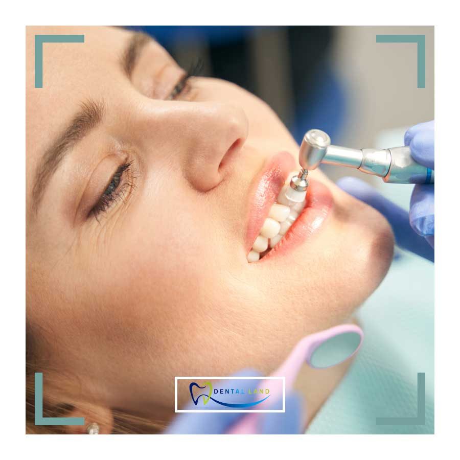 A dentist performing periodontics on a woman's teeth, ensuring oral health