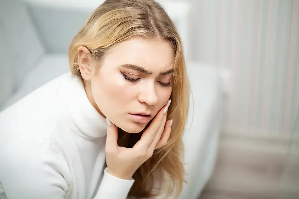 tired-woman-keeping-hand-on-her-head Quick Reference: Typical Wisdom Teeth Removal Recovery Time